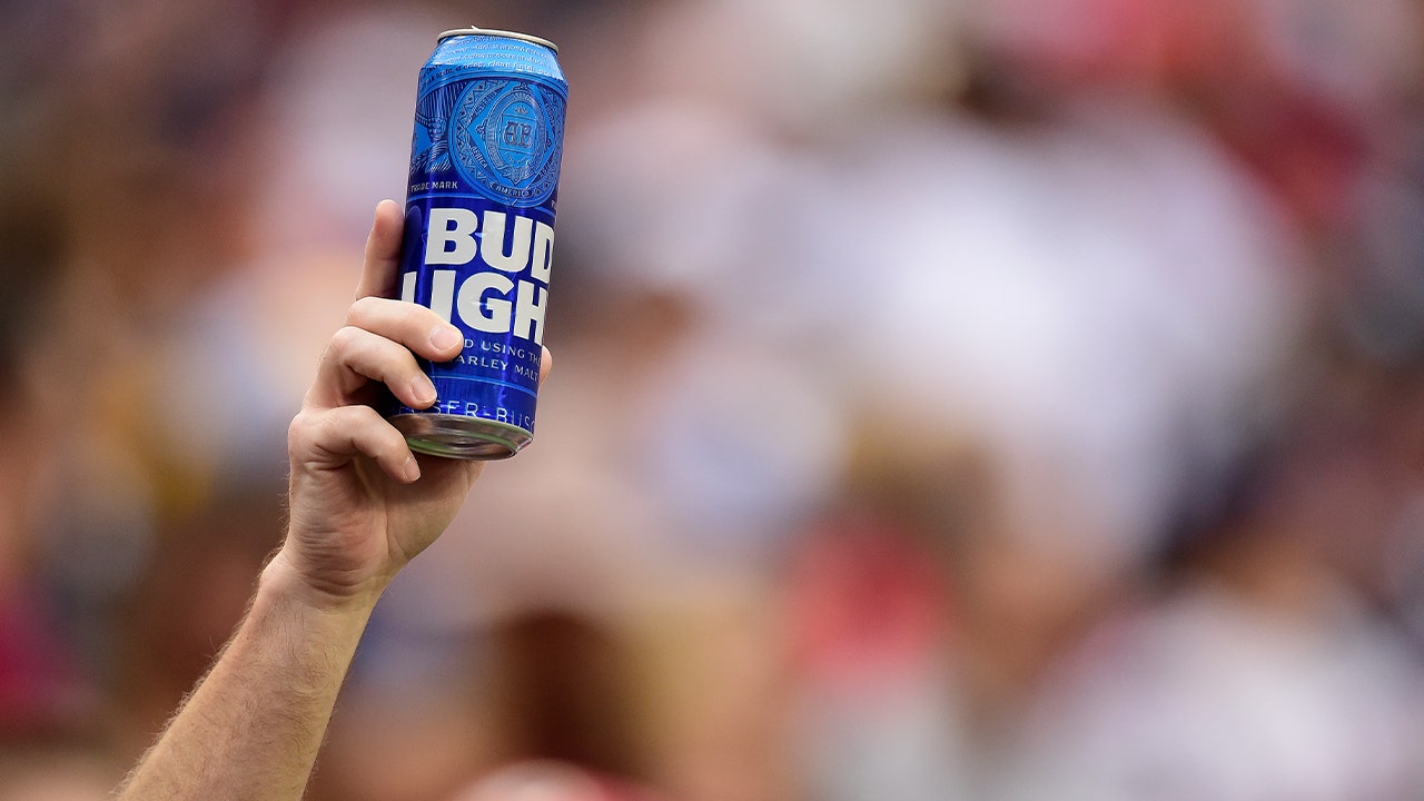 Football-fan-holds-up-Bud-Light-can.jpg