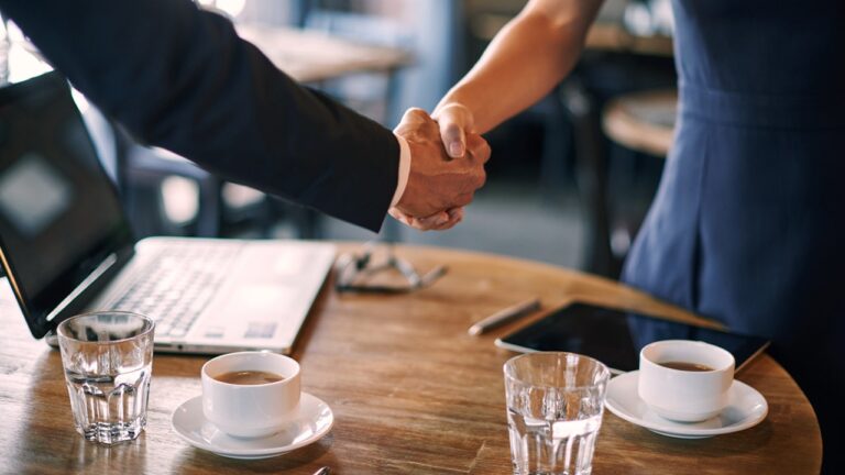 handshake-over-coffee-cups-iStock-542102304.jpg