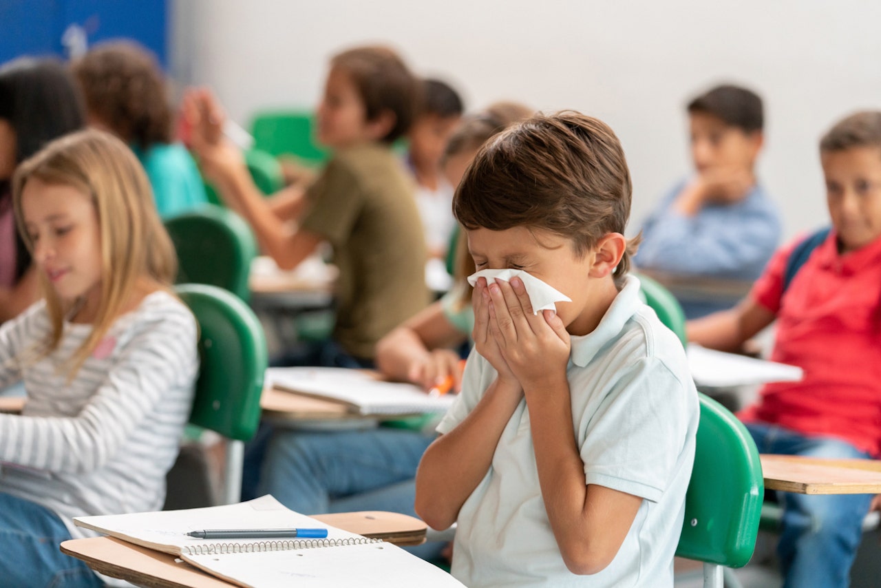 boy-blowing-nose-in-school.jpg