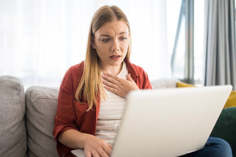 woman-holding-chest-at-computer.jpg