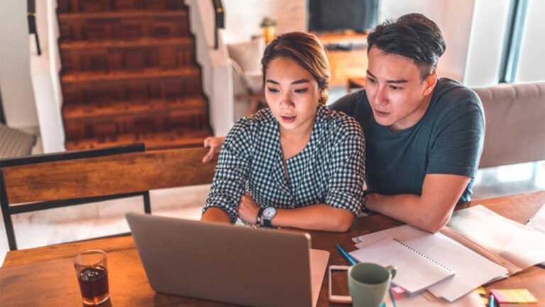 16fe27b8-serious-couple-looking-at-laptop-and-discussing-finances.jpg