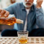 older-man-pouring-whiskey.jpg