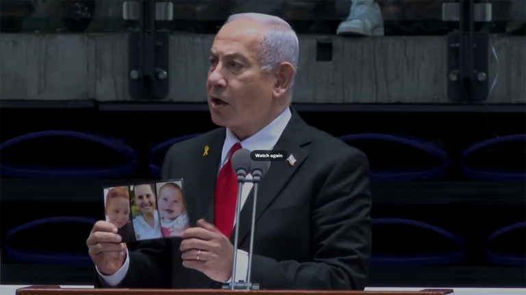 netanyahu-holds-up-bibas-family-photo.png